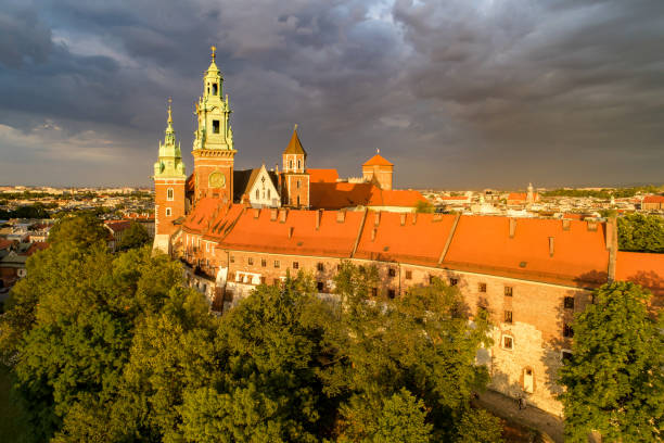Wawel Cathedral in Krakow, Poland. Aerial view with dark clouds Historic royal Wawel Cathedral in Cracow, Poland. Aerial view in sunset light with dark stormy clouds wawel cathedral stock pictures, royalty-free photos & images