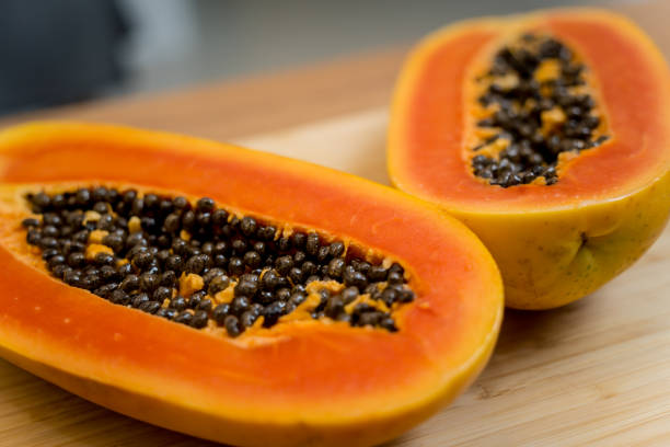 istock Chef cuts and peels papaya on the cutting board 2154723418