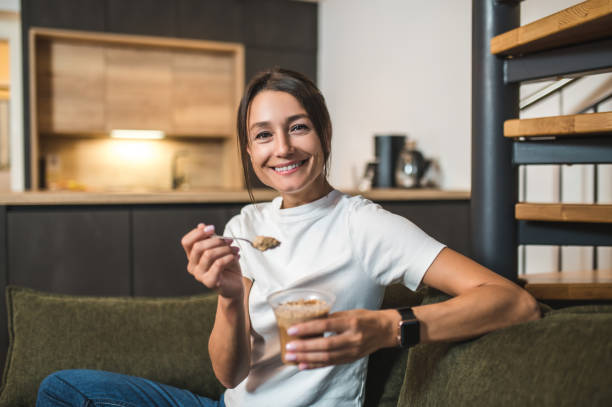istock Young woman spending time at home and enjoying a dessert 2154725965
