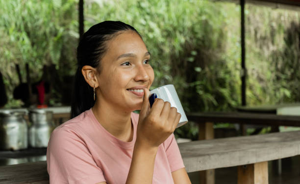 istock young latina woman holding a cup 2154726283