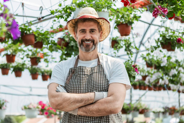 istock Mature Worker in Greenhouse Looking At Camera 2154726332