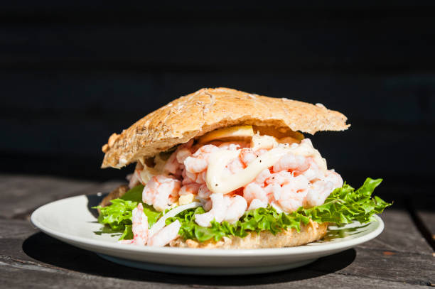 istock White Plate With Sandwich on Wooden Table 2154726716