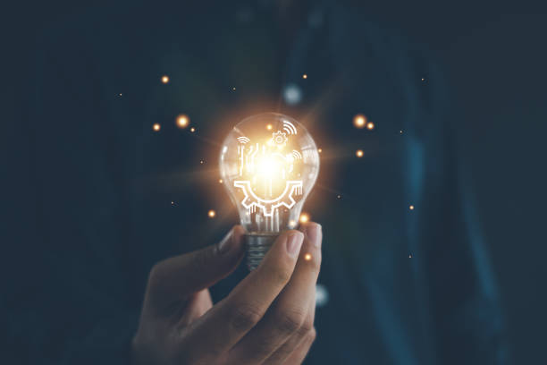istock Idea innovation and inspiration concept.Hand of man holding illuminated light bulb, Idea innovation and inspiration concept.  creativity with bulbs that shine glitter, Concept for success. 2154728348