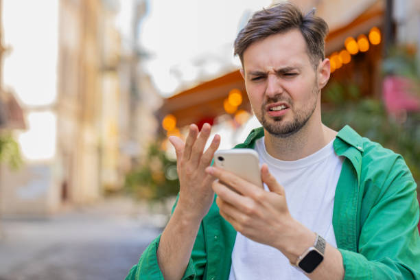 istock Sad man using smartphone browsing loses lottery casino application results bad news fail virus 2154730830