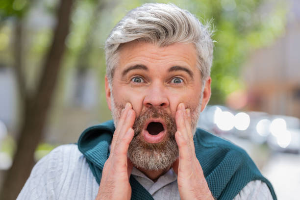 istock Excited amazed mature man looking surprised at camera with big open eyes shocked by sudden victory 2154731029