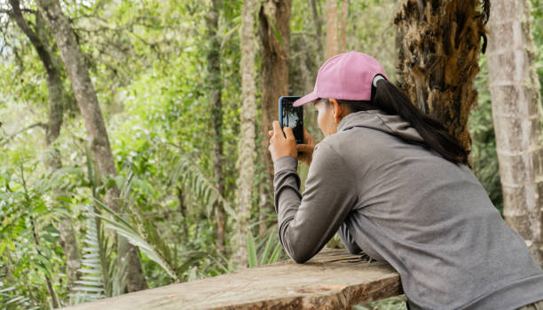 istock young woman outdoors taking a picture with a mobile phone 2154731549
