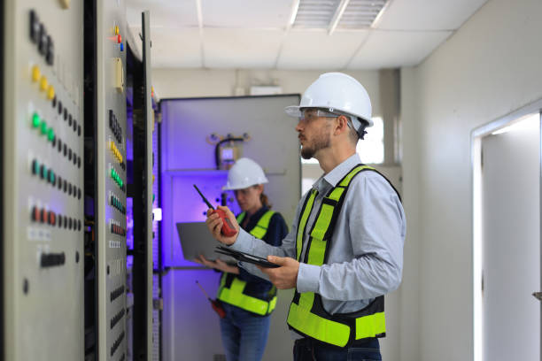 istock Two Caucasian white professional electrician engineers working with a computer and digital tablet in the main electric control room of the factory, MDB Main Distribution Board 2154732284