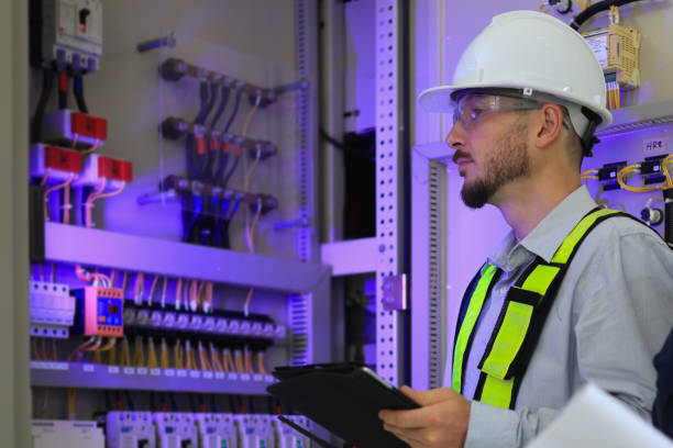 istock A male working with a digital tablet in front of the electric control panel. Engineers working at substation electric panel. 2154732346
