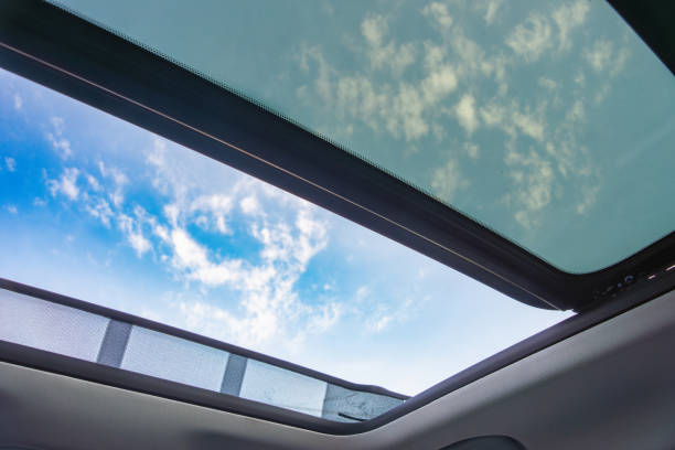 istock Open Car Sunroof with Blue Sky View 2154734376