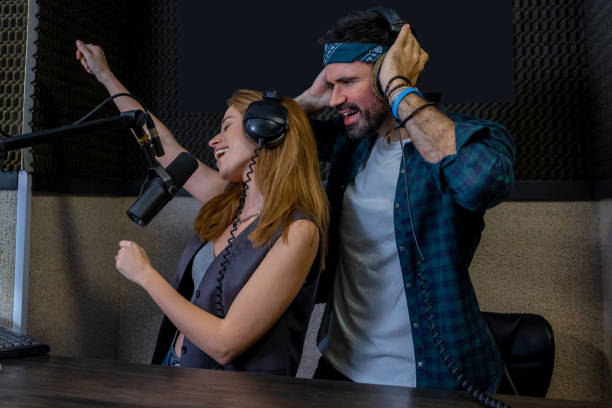 istock Duet singing in radio station hosting live show 2154735310