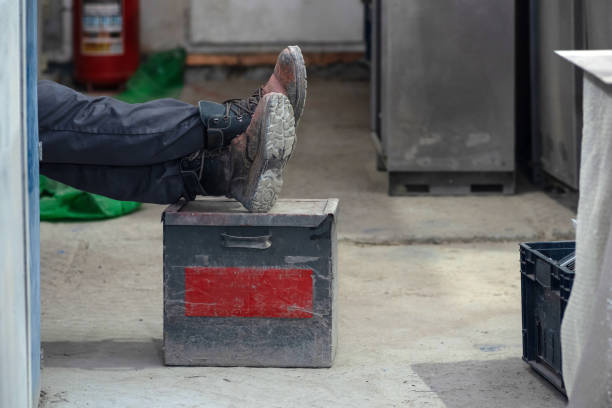 black leather shoe on the left with a hole in the toe