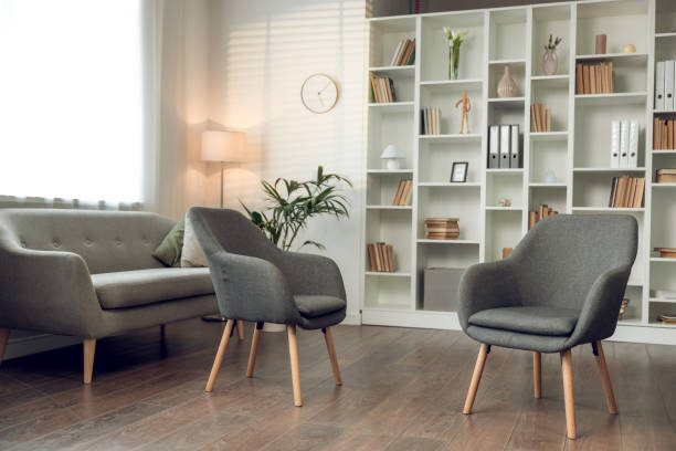istock Psychologists office with cozy chairs sofa and shelves with books 2154737899
