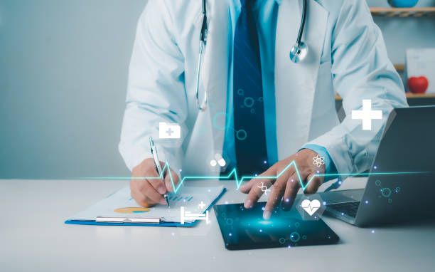 istock Male doctor using tablet to review treatment plan and write document reports in hospital office, Healthcare worker and doctor service, Digital laptop in modern office, Medical technology concept. 2154739753