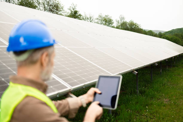 istock Engineer checking the work of a solar energy collector 2154739863