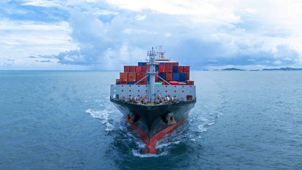 istock Front view of  Cargo container ship carrying container and running out international container port customs shipyard sea port concept smart logistic service. 2154740449
