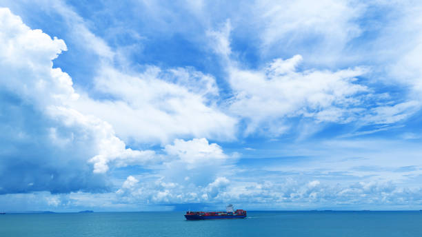 istock Side Cargo container ship on beautiful sky cloud carrying container and running out international container port customs shipyard sea port concept smart logistic 2154740530