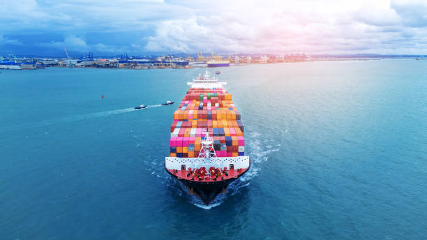 istock Front view of  Cargo container ship carrying container and running out international container port customs shipyard sea port concept smart logistic service. 2154740688