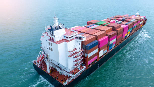 istock stern view Cargo Container ship the ocean ship carrying container and running for import export concept technology freight shipping by ship . aerial top of Container Vessel running in green sea 2154740721
