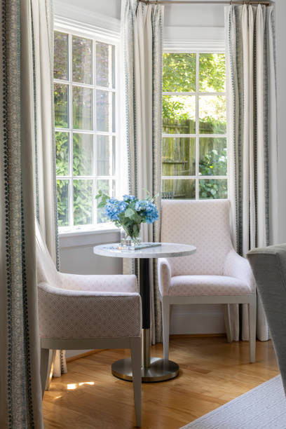 istock Cozy Intimate Seating Area with Flowers on Table Overlooking Gardens 2154741700
