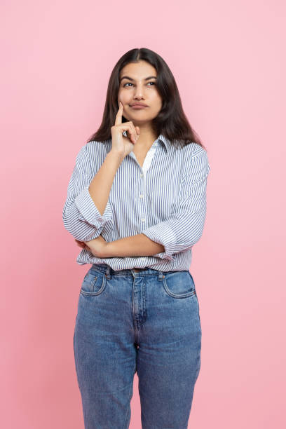 istock Thoughtful Indian woman holding chin thinking 2154743403