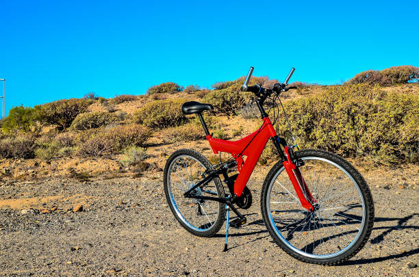 istock A red bicycle is parked on a rocky hillside 2154743771