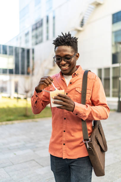 istock Young man having a lunch outdoors 2154752204