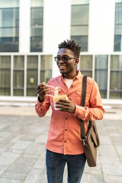 istock Young man having a lunch outdoors 2154752264