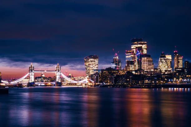 Tower bridge and London skyline at night, UK