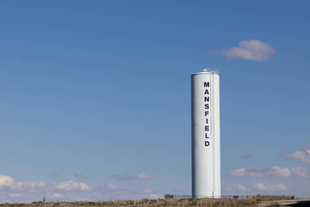 Low angle view of agriculture grain elevators under a cloudy stormy sky. Taken in the Sacramento Valley, California, USA