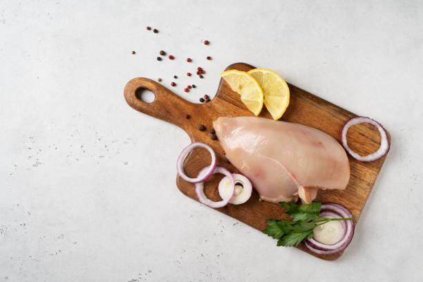 istock Chicken breast uncooked fresh with pepper and onion 2154755499