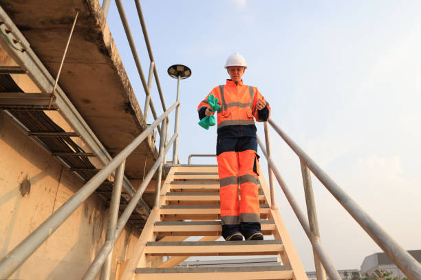 istock Snapshot Environment engineer with orange safety jacket and PPE Going down the stairs work at wastewater plant, Industrial, and environment 2154756743