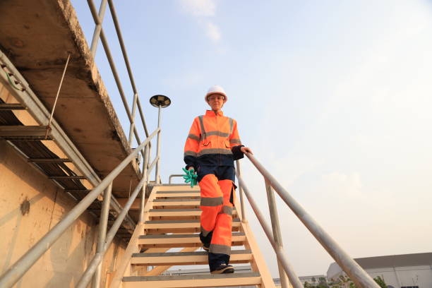 istock Snapshot Environment engineer with orange safety jacket and PPE Going down the stairs work at wastewater plant, Industrial, and environment 2154756746