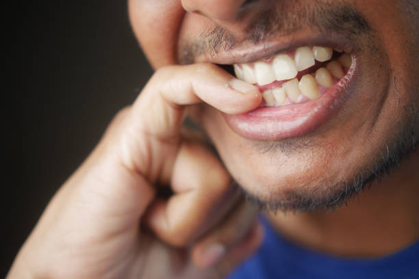 istock young men biting his nails at home, 2154757903
