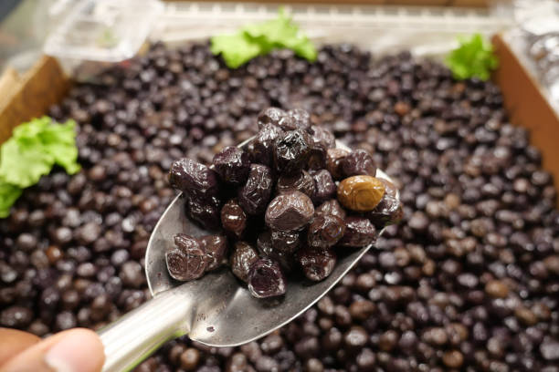 istock slices black olives with spoon in a bowl , 2154758056