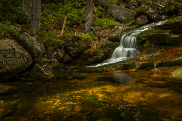 Jeleni waterfall in spring sunny cloudy day in fresh color Jizerske mountains