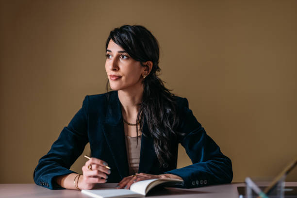 istock Professional Woman Deep in Thought at Office Desk 2154762860