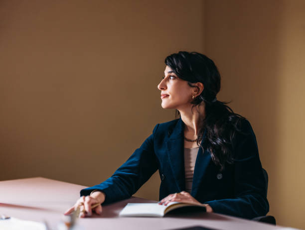 istock Confident Professional Woman Looking Thoughtfully in Office 2154762910