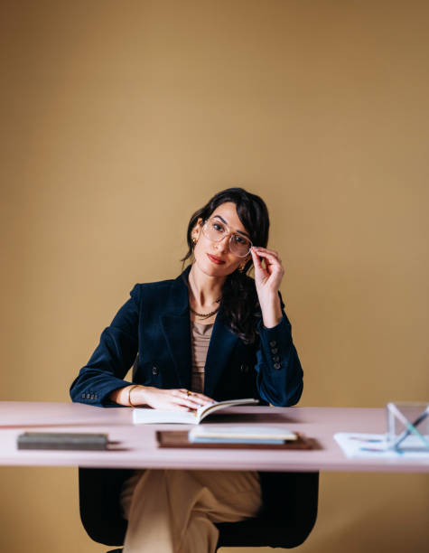 istock Confident Businesswoman in Stylish Office Setting Reading 2154762945