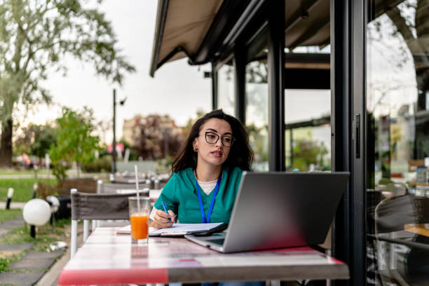 istock Notebook engagement for young nurse in cafe garden 2154764387