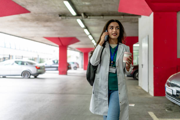 istock Engrossed in call, nurse stands in garage 2154764962