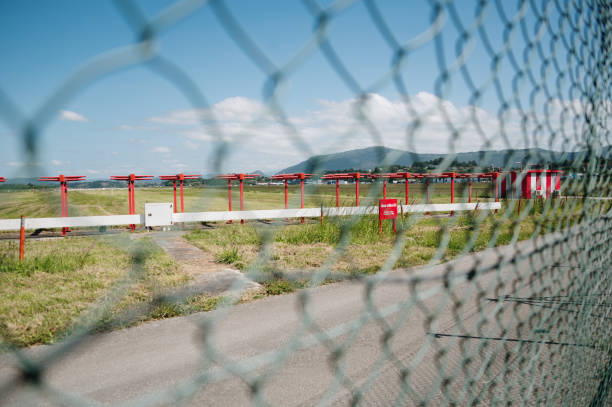 Airport runway as seen from behind a fence