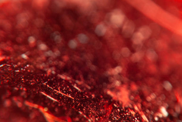 This image captures the detailed texture of a surface with a complex pattern enhanced by contrasting red and blue hues.