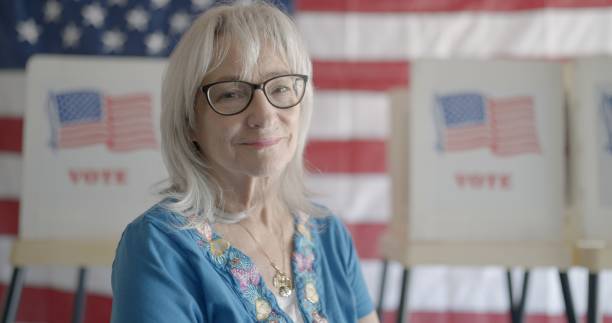 istock Smiling elderly woman election worker ready for voters 2154771541