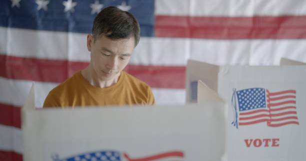 istock Frontal close up, Asian man casting votes in United States election 2154771583
