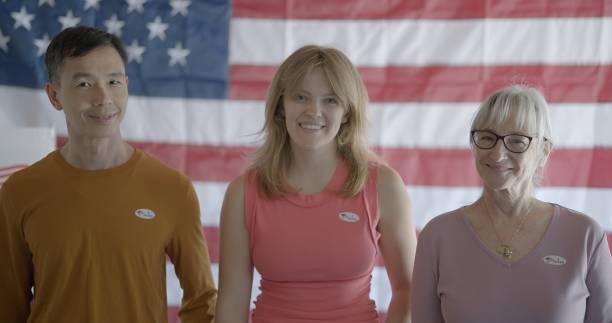 istock Three voters smiling and wearing 