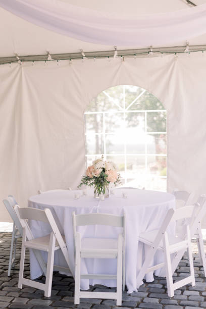 istock A wedding reception table decorated with a simple a flower arrangement 2154772949