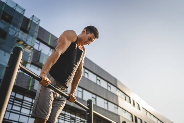istock One man muscular male athlete training pull ups outdoor in sunny day 2154773217