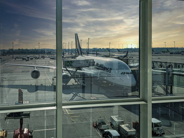 Munich, Germany - May 11 2024: docked Airbus a 380 prepared for flight with attached jet bridges for boarding passengers in Munich, Germany