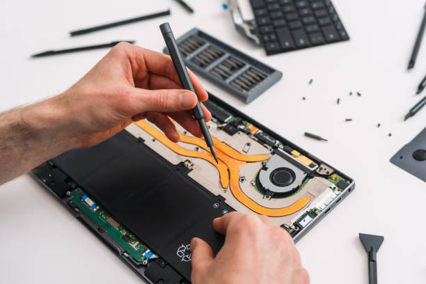 istock POV man repairing his laptop using a screwdriver. 2154775920