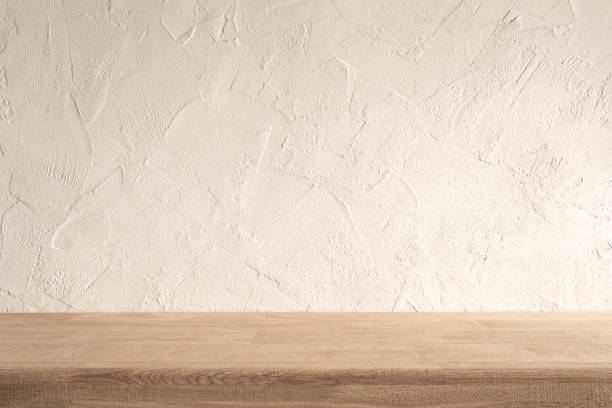 istock Minimalist Wooden Kitchen Counter With Textured Wall in Daytime Setting 2154778210